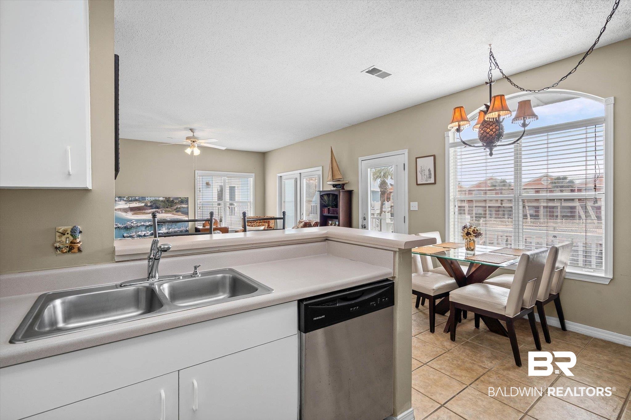 3575 Bayou Road, Unit B2 Orange Beach, AL 36561 - Photo 8 of 35 Kitchen featuring white cabinets, dishwasher, hanging lights, a peninsula, and light countertops