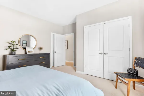 a bedroom with a bed and a dresser