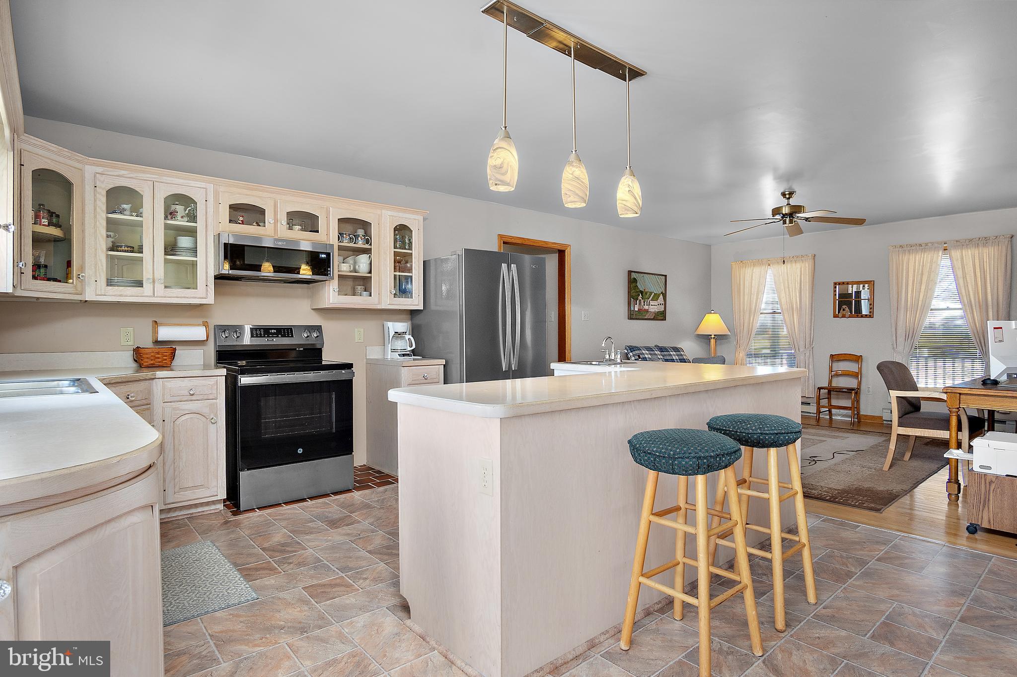 13810 Franks Run Road Smithsburg, MD 21783 - Photo 17 of 72 a kitchen with stainless steel appliances kitchen island a refrigerator and a stove