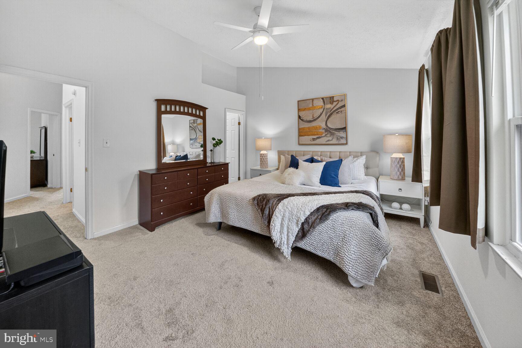 4303 Thistlewood Terrace Burtonsville, MD 20866 - Photo 12 of 26 a bedroom with a bed and dresser with mirror