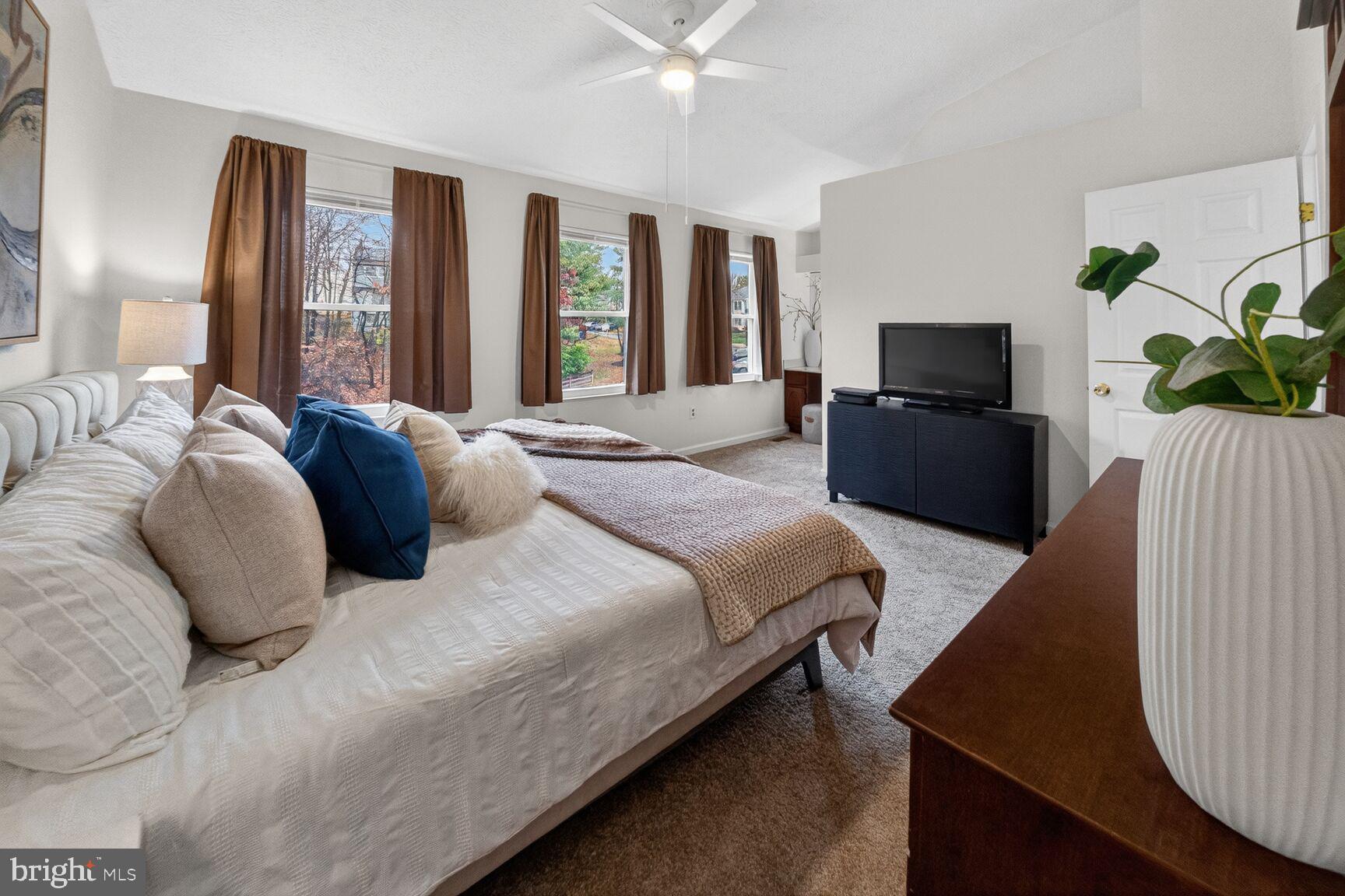 4303 Thistlewood Terrace Burtonsville, MD 20866 - Photo 14 of 26 a bedroom with a bed and a flat screen tv