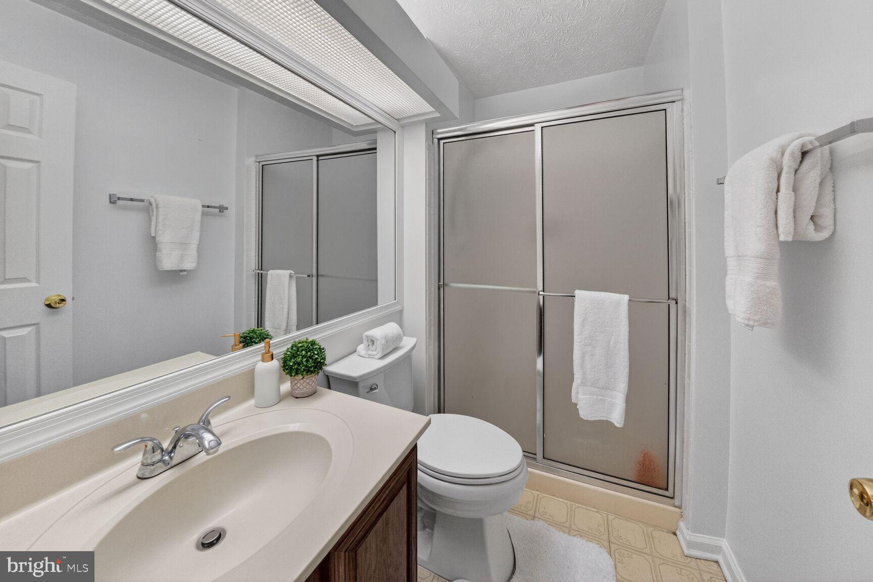 4303 Thistlewood Terrace Burtonsville, MD 20866 - Photo 15 of 26 a bathroom with a sink toilet and shower