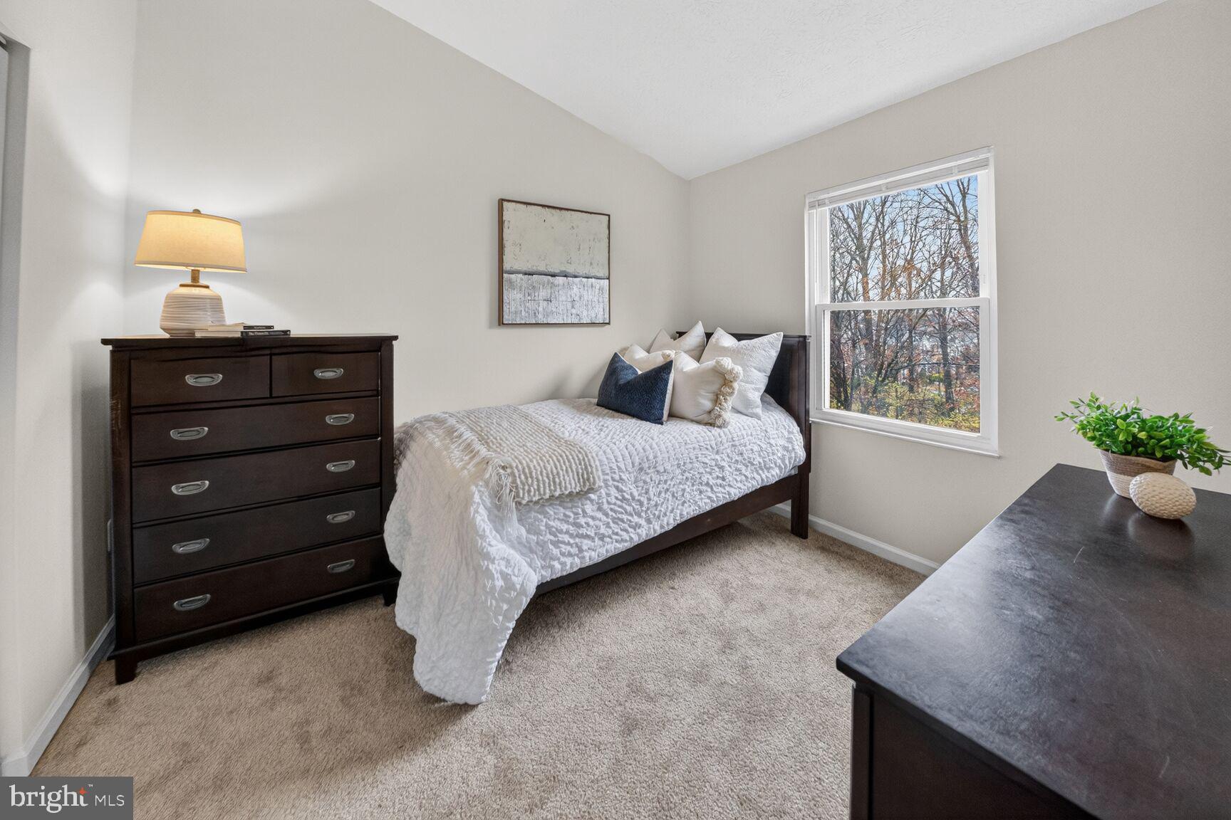 4303 Thistlewood Terrace Burtonsville, MD 20866 - Photo 18 of 26 a bedroom with a bed and a table in it