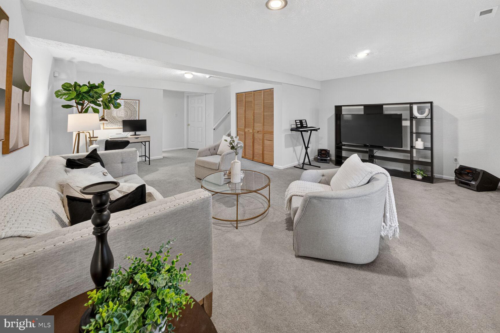 4303 Thistlewood Terrace Burtonsville, MD 20866 - Photo 22 of 26 a living room with furniture and a flat screen tv