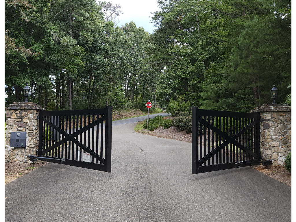 241 Carter Road, Unit 241 Ellijay, GA 30536 - Photo 18 of 19 Private Automatic Gate, Stone pillar entrance with integrated lighting and a black iron gate with automatic openers