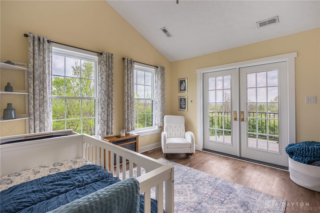 9586 Ferry Road Waynesville, OH 45068 - Photo 18 of 40 This airy bedroom offers serene outdoor views, creating a peaceful and inviting atmosphere.