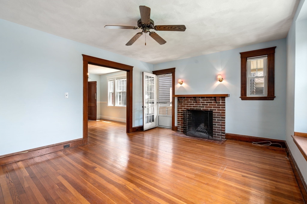 7 Winslow Road Belmont, MA 02478 - Photo 15 of 27 a view of an empty room with wooden floor fireplace and a window
