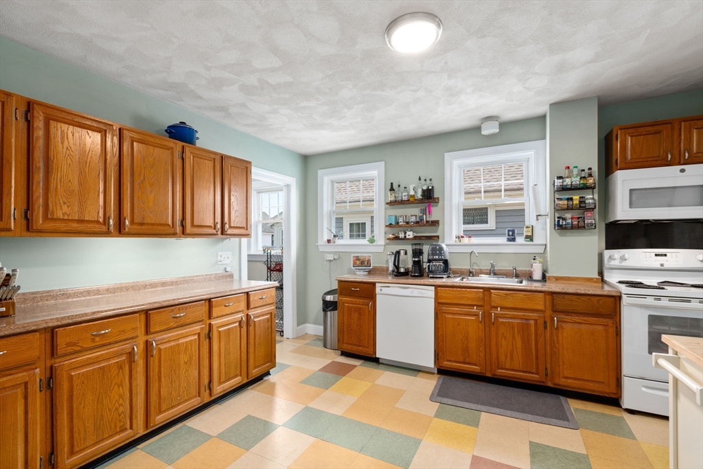 7 Winslow Road Belmont, MA 02478 - Photo 7 of 27 a kitchen with stainless steel appliances granite countertop a sink dishwasher stove and refrigerator with wooden floor