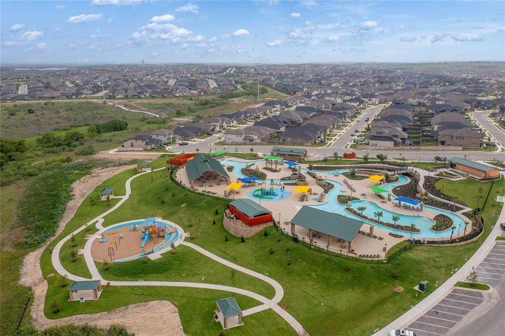 757 Cherrystone Loop Buda, TX 78610 - Photo 30 of 33 An aerial perspective reveals a vibrant community with recreational amenities and residential neighborhoods.