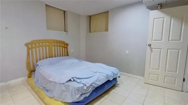 a bedroom with a bed and dresser