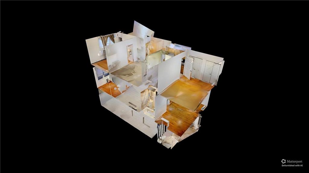 67 Stryker Street Brooklyn, NY 11223 - Photo 17 of 20 a view of water heater room with water heater and wooden floor