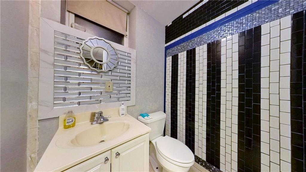 67 Stryker Street Brooklyn, NY 11223 - Photo 8 of 20 a bathroom with a sink toilet and shower