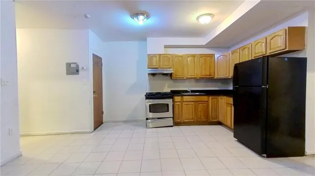 a kitchen with a refrigerator and a stove