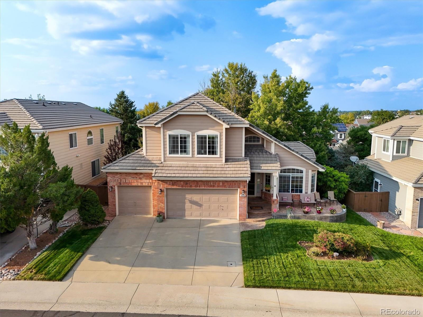 3115 White Oak Lane Highlands Ranch, CO 80129 - Photo 2 of 43 a front view of a house with a garden