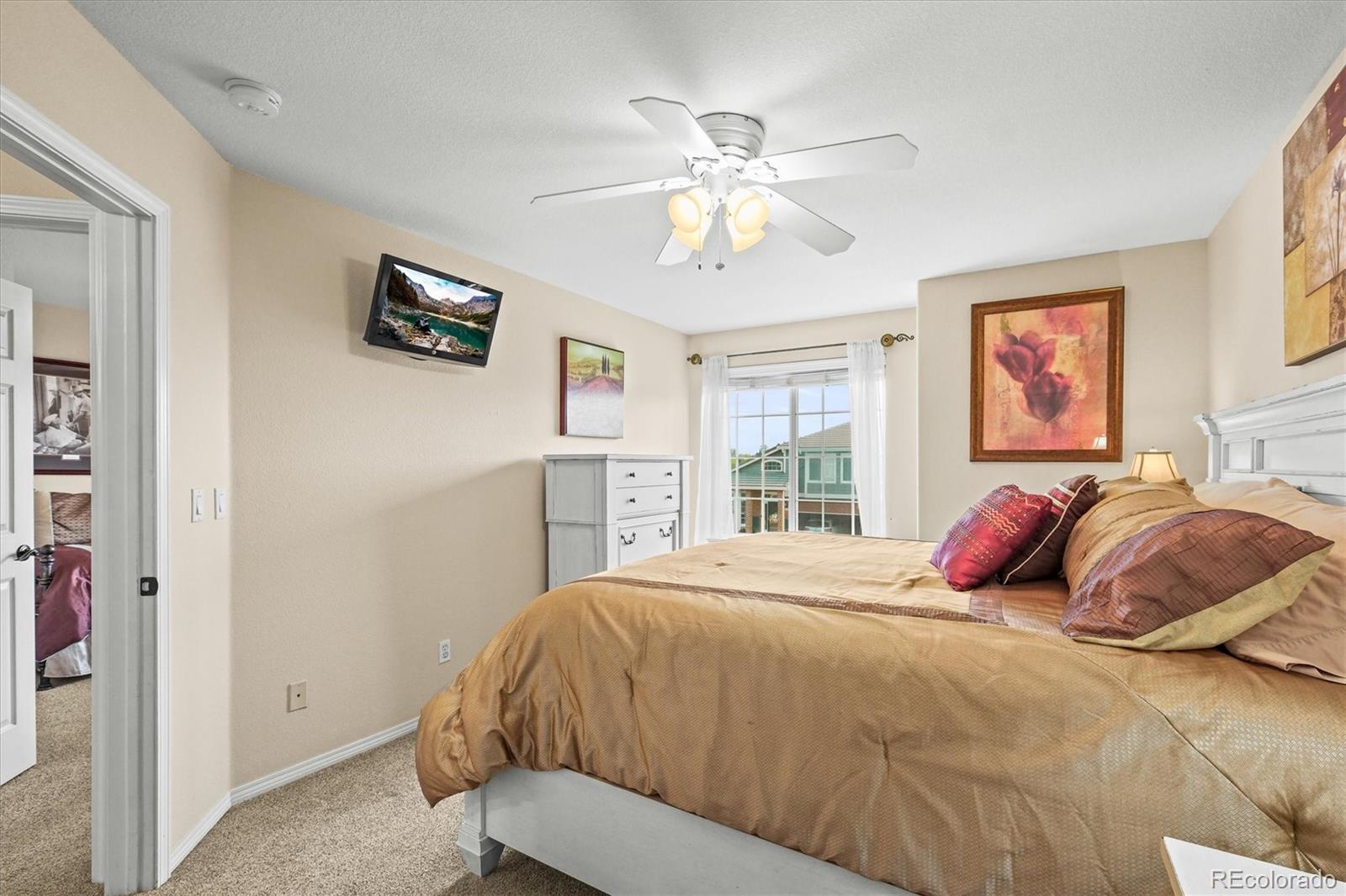 3115 White Oak Lane Highlands Ranch, CO 80129 - Photo 22 of 43 a bedroom with a bed and a chandelier