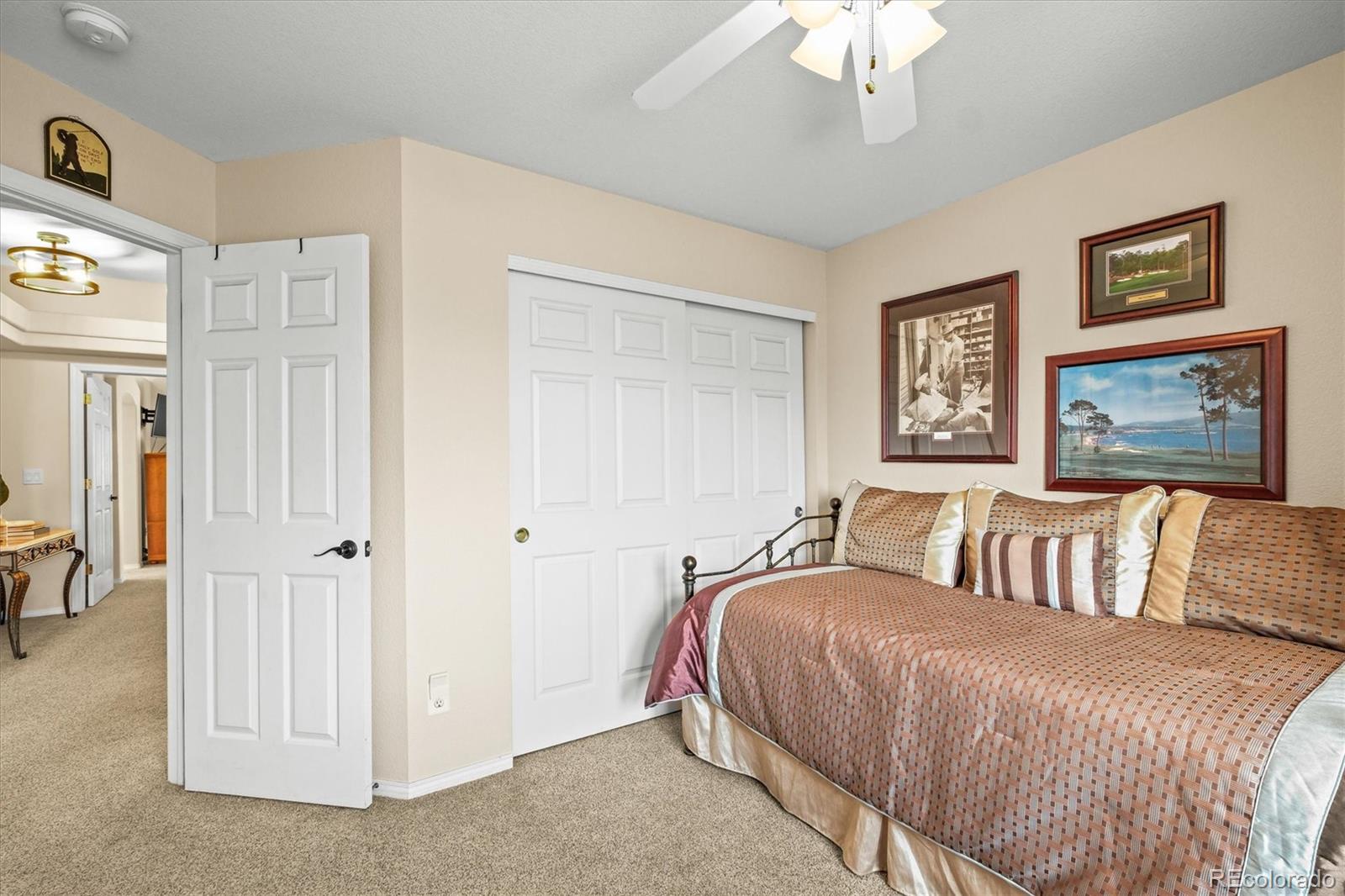 3115 White Oak Lane Highlands Ranch, CO 80129 - Photo 23 of 43 a bedroom with a large bed and a chandelier