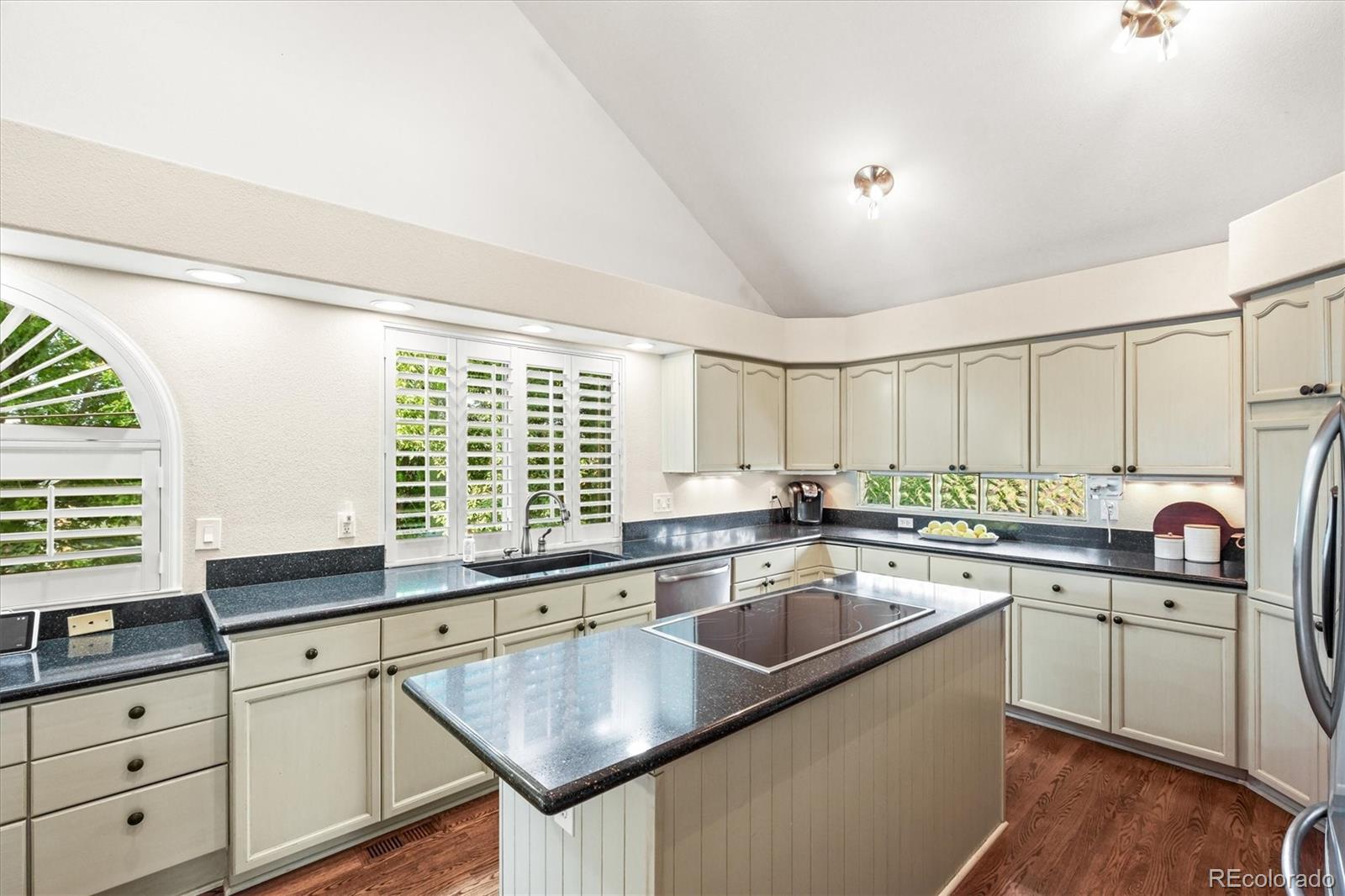 3115 White Oak Lane Highlands Ranch, CO 80129 - Photo 9 of 43 a kitchen with stainless steel appliances granite countertop a sink a stove and cabinets