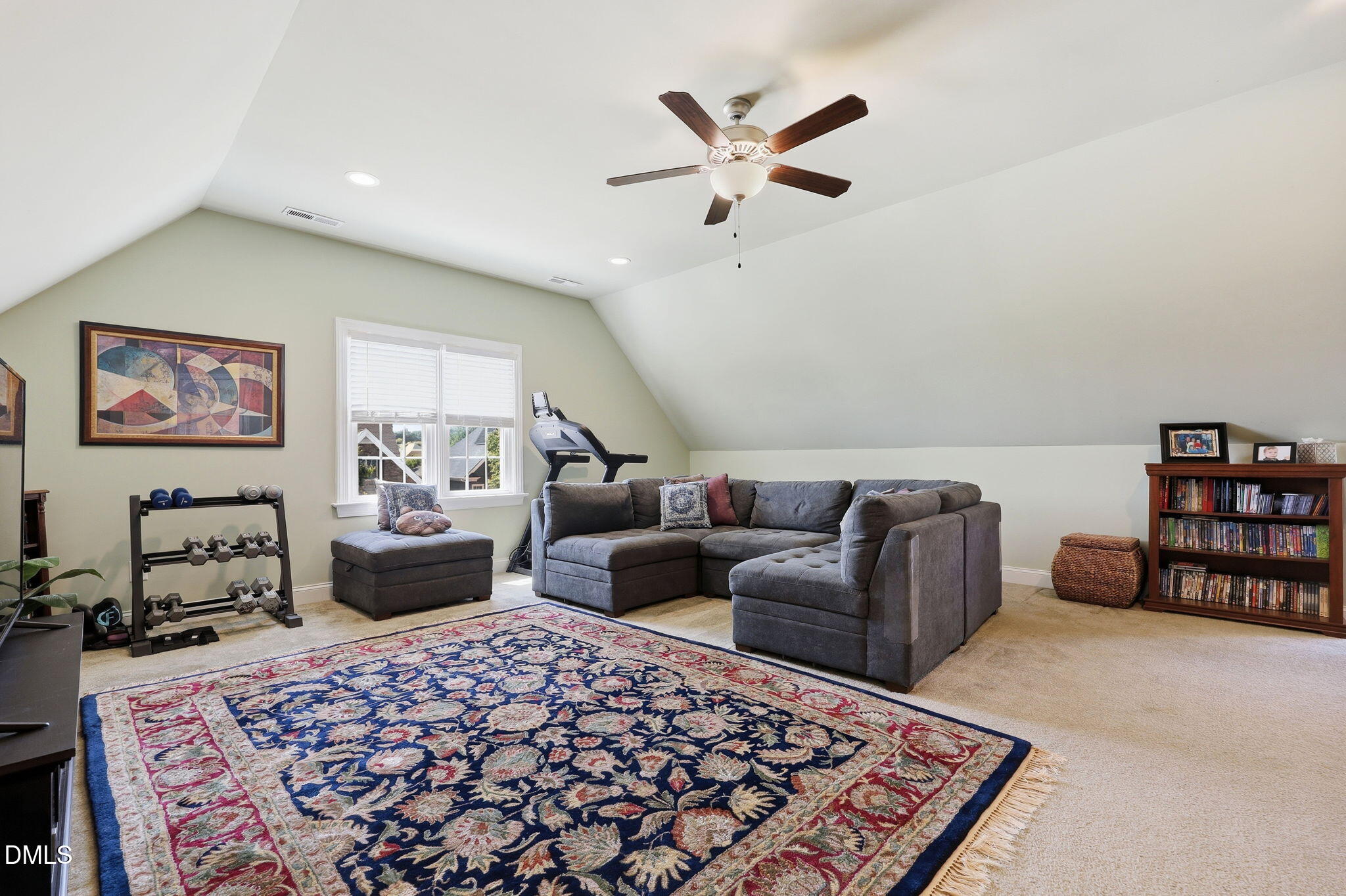 7040 Dayton Ridge Drive Apex, NC 27539 - Photo 24 of 38 a living room with furniture or couch and a bookshelf