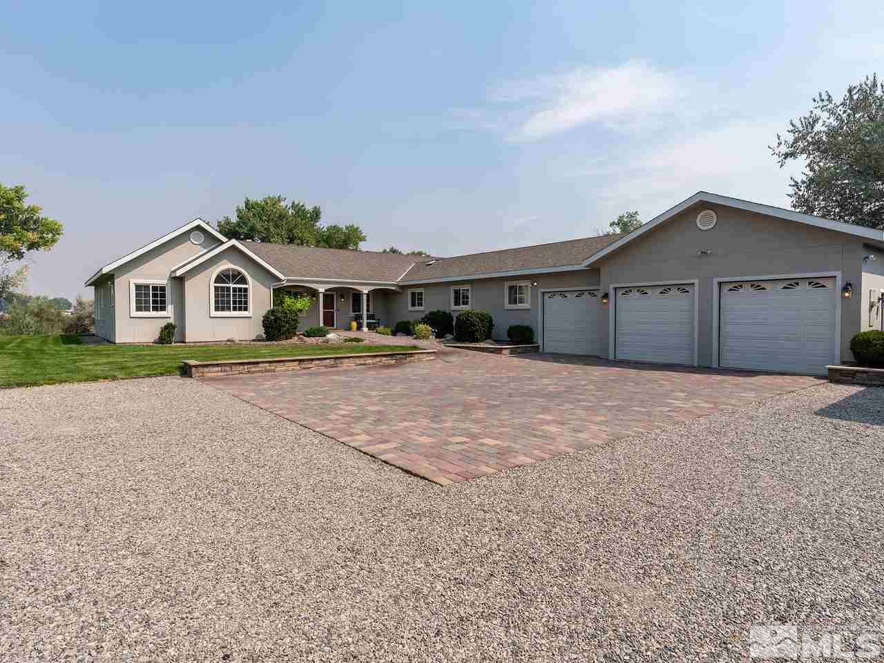 5112 Rivers Edge Drive Fallon, NV 89406 - Photo 1 of 25 a front view of a house with a yard and garage