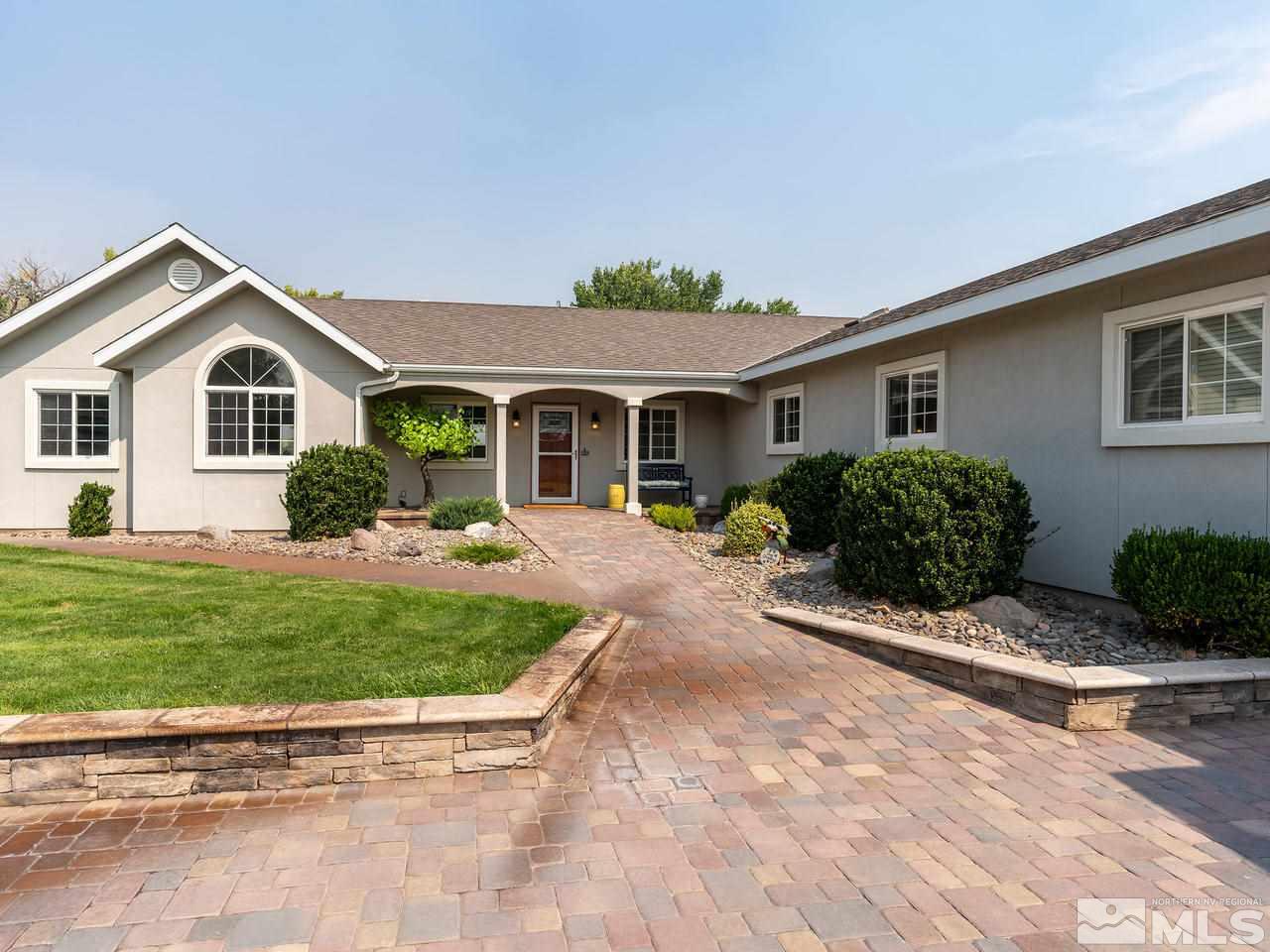 5112 Rivers Edge Drive Fallon, NV 89406 - Photo 2 of 25 a front view of a house with a yard and garage