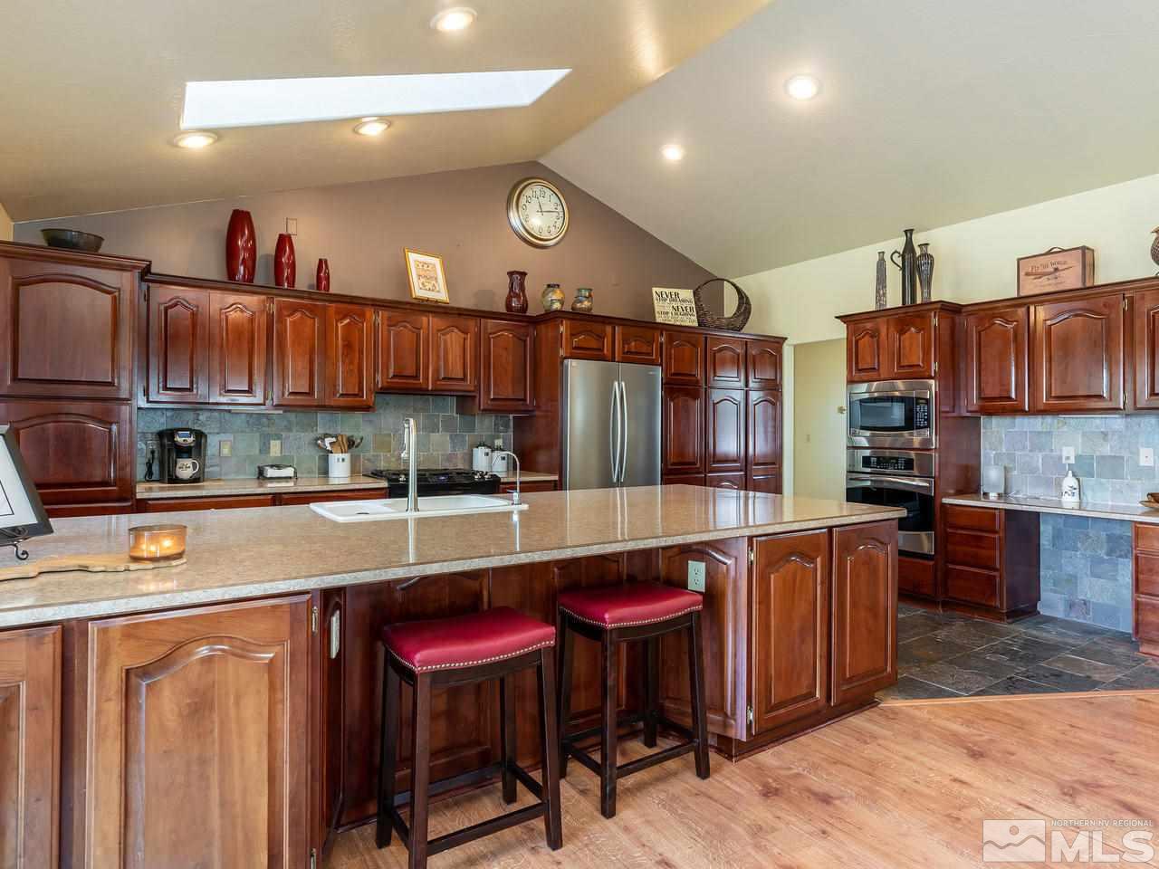 5112 Rivers Edge Drive Fallon, NV 89406 - Photo 8 of 25 a kitchen with stainless steel appliances granite countertop a sink and cabinets