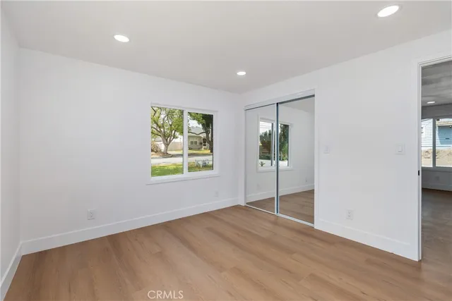 an empty room with windows and cabinet