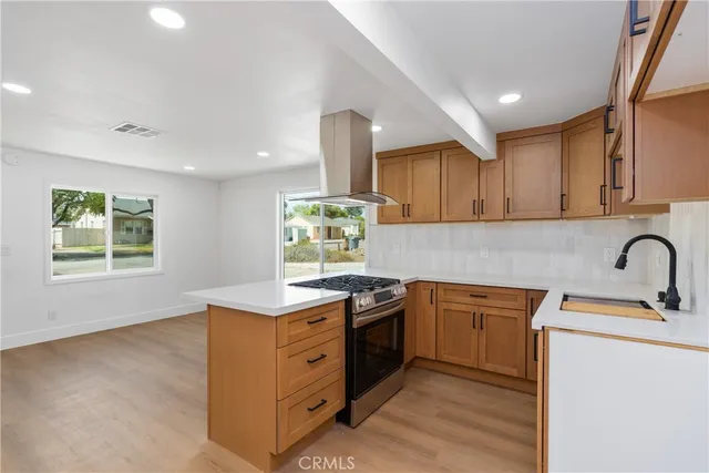 a kitchen with a sink cabinets and window