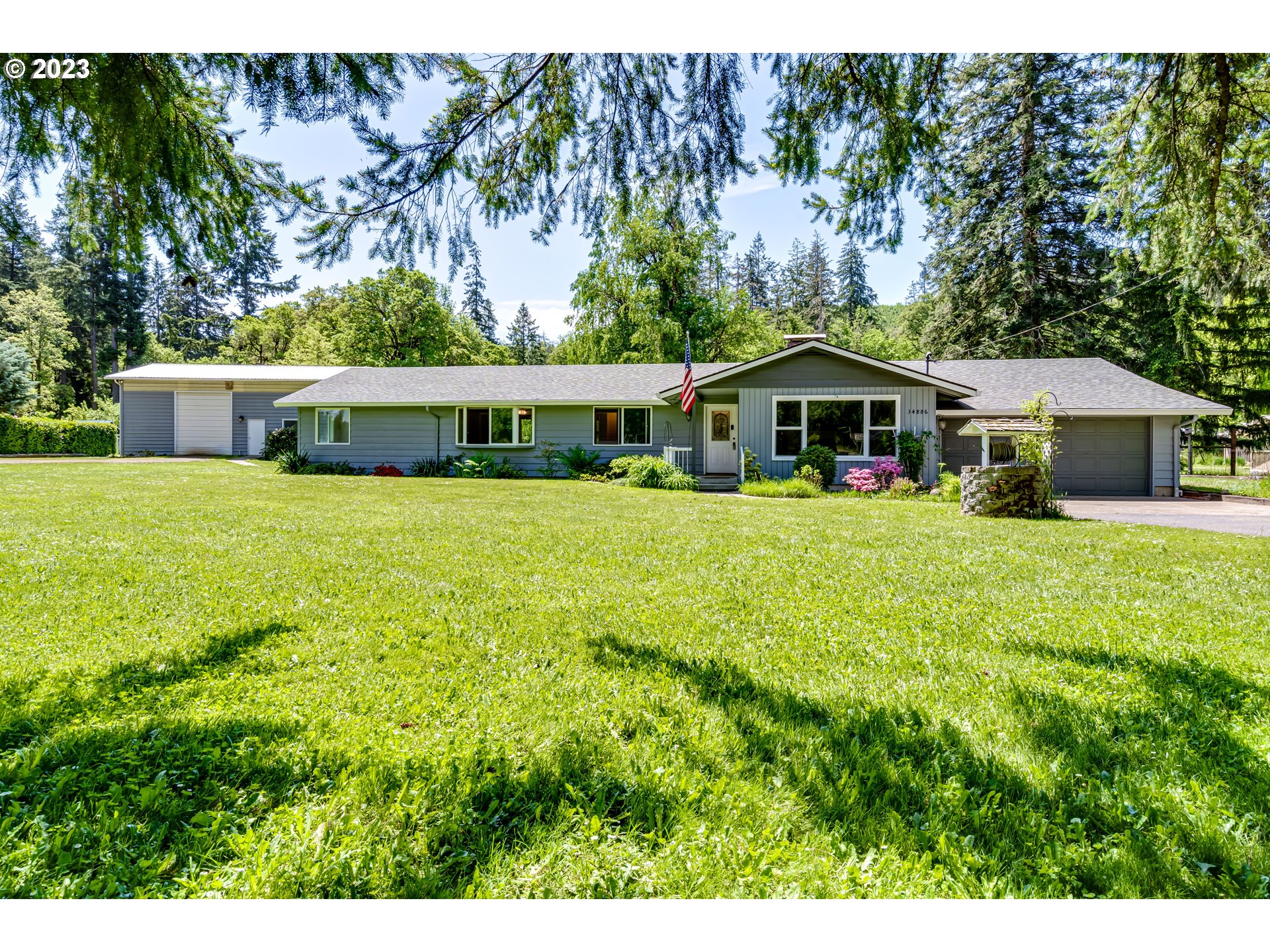 34886 Mathews Road Eugene, OR 97405 - Photo 1 of 48 a view of a house with a garden and trees