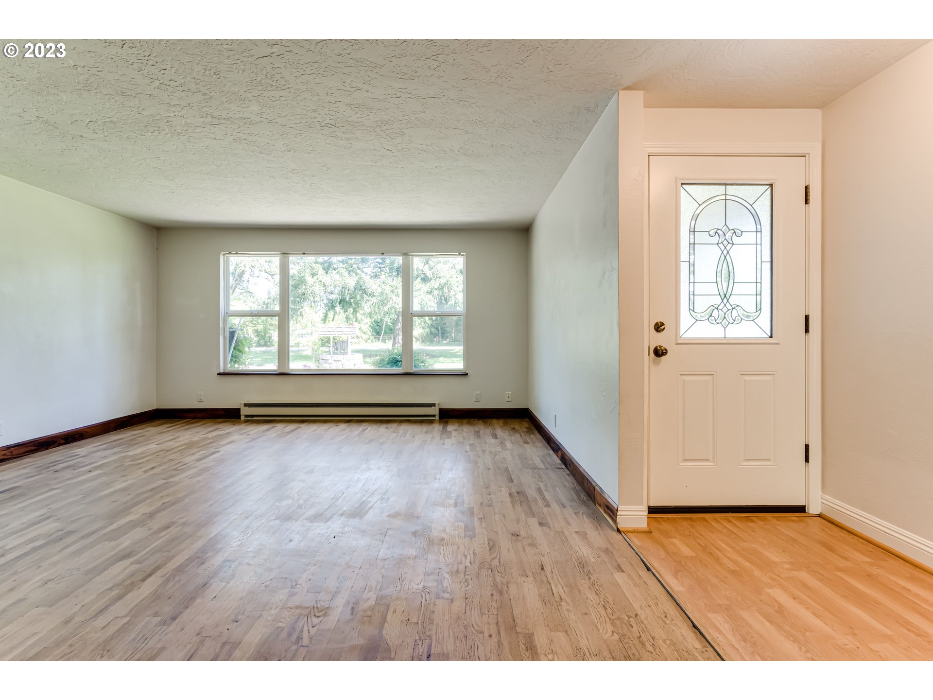 34886 Mathews Road Eugene, OR 97405 - Photo 11 of 48 an empty room with wooden floor and windows