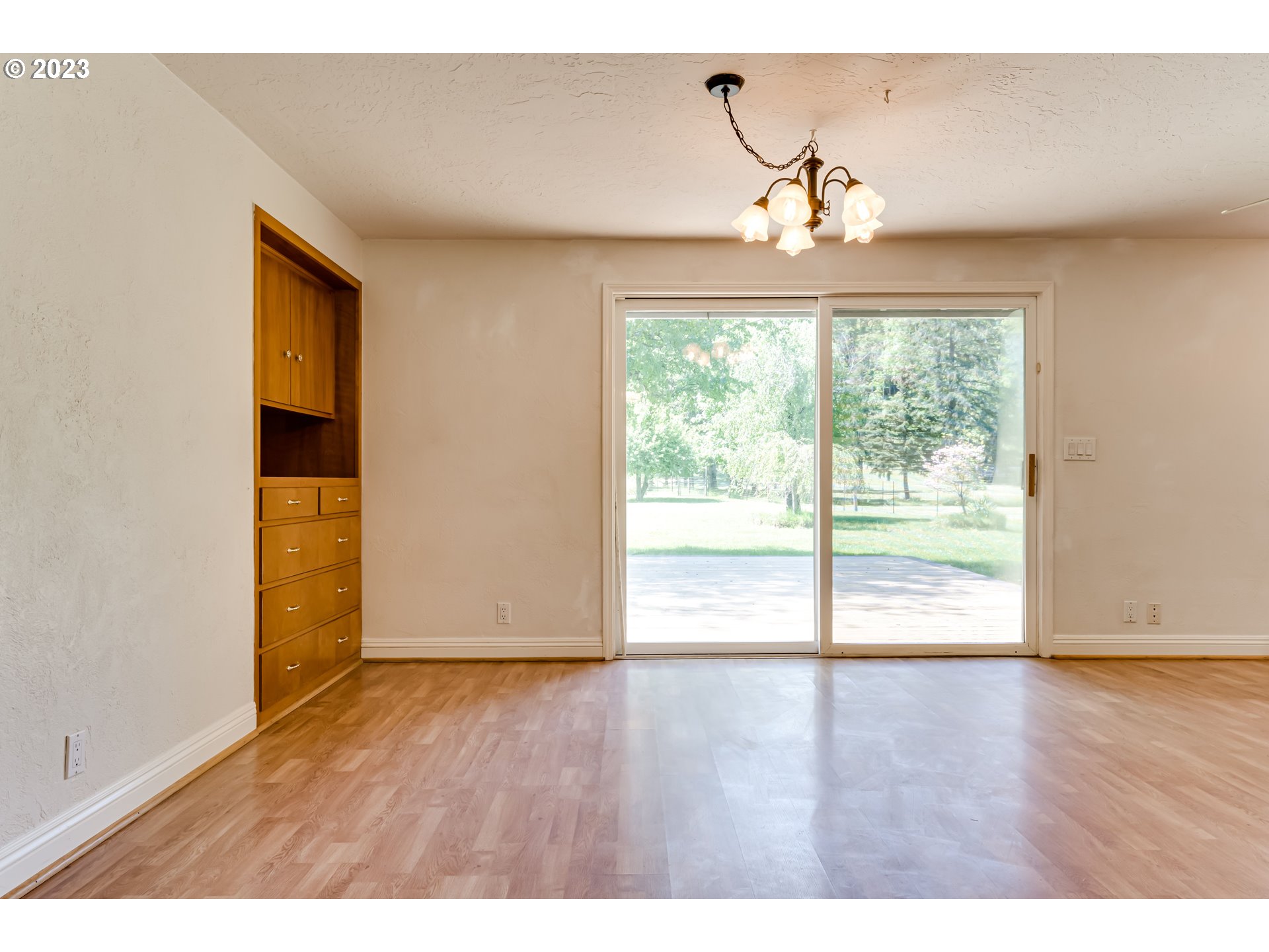 34886 Mathews Road Eugene, OR 97405 - Photo 13 of 48 a view of an empty room with wooden floor and a window
