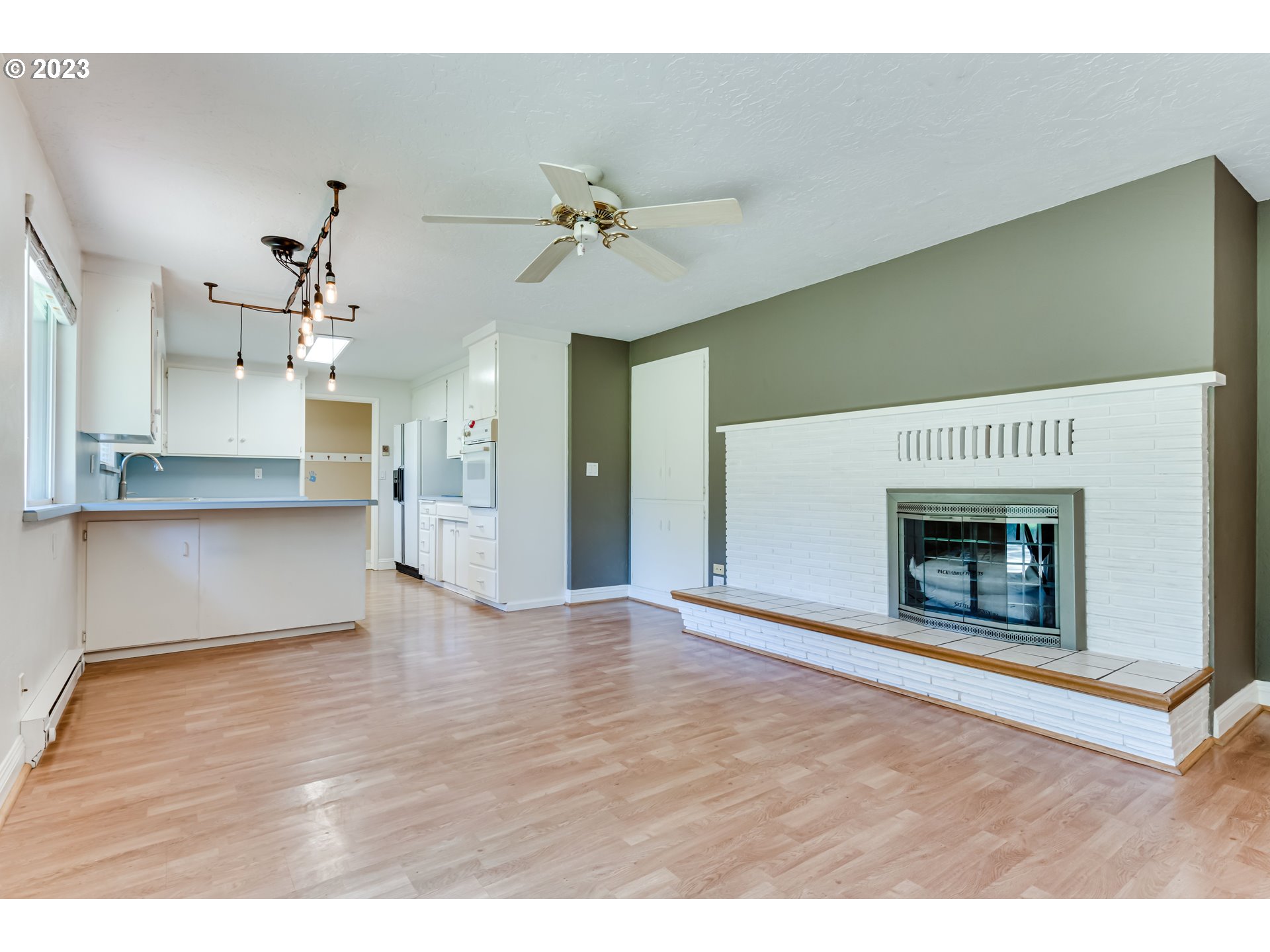 34886 Mathews Road Eugene, OR 97405 - Photo 15 of 48 a view of an empty room with a kitchen and a fireplace