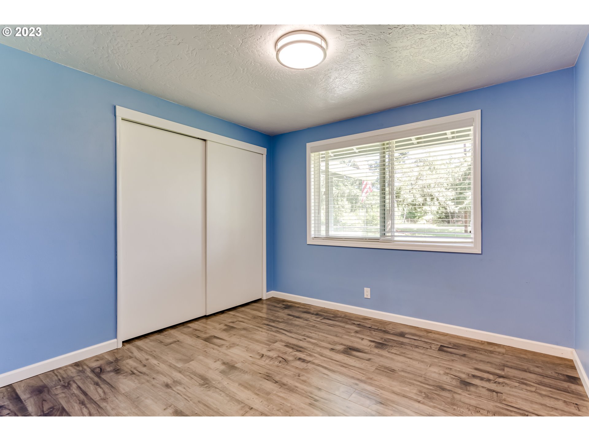 34886 Mathews Road Eugene, OR 97405 - Photo 22 of 48 a view of an empty room with wooden floor and a window