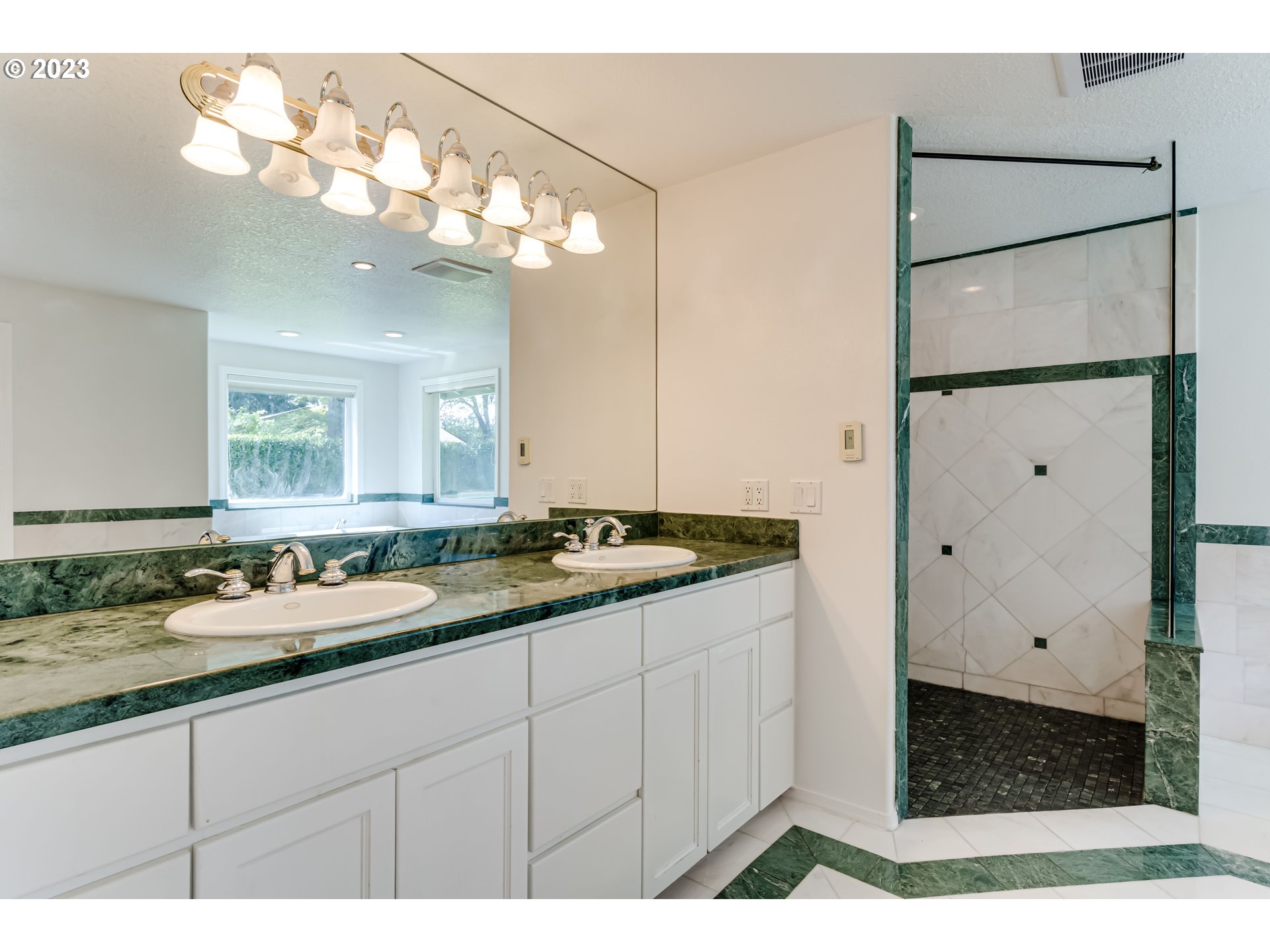 34886 Mathews Road Eugene, OR 97405 - Photo 27 of 48 a bathroom with a granite countertop sink a mirror and a shower
