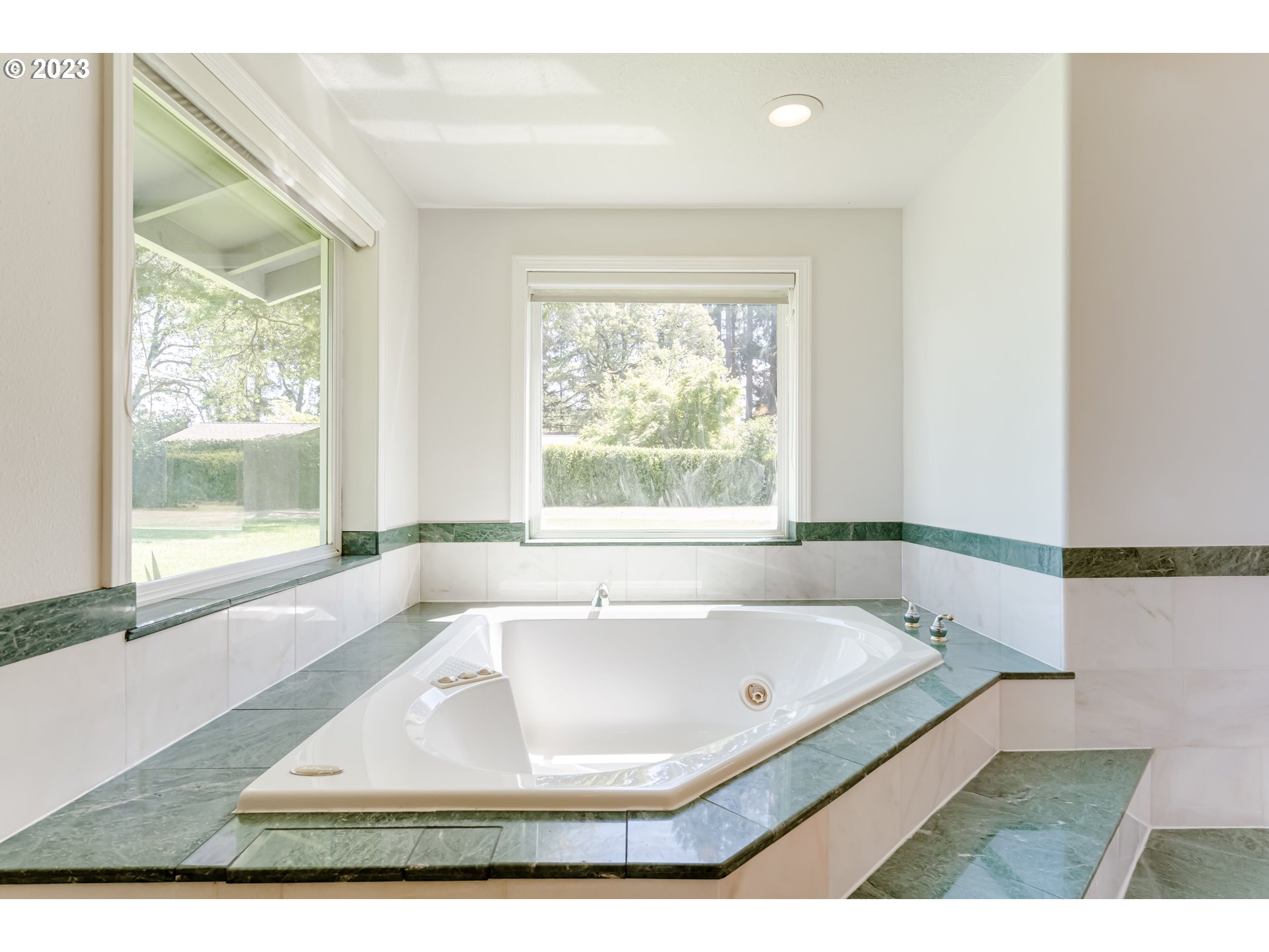 34886 Mathews Road Eugene, OR 97405 - Photo 30 of 48 a white bath tub sitting in a bathroom next to a window