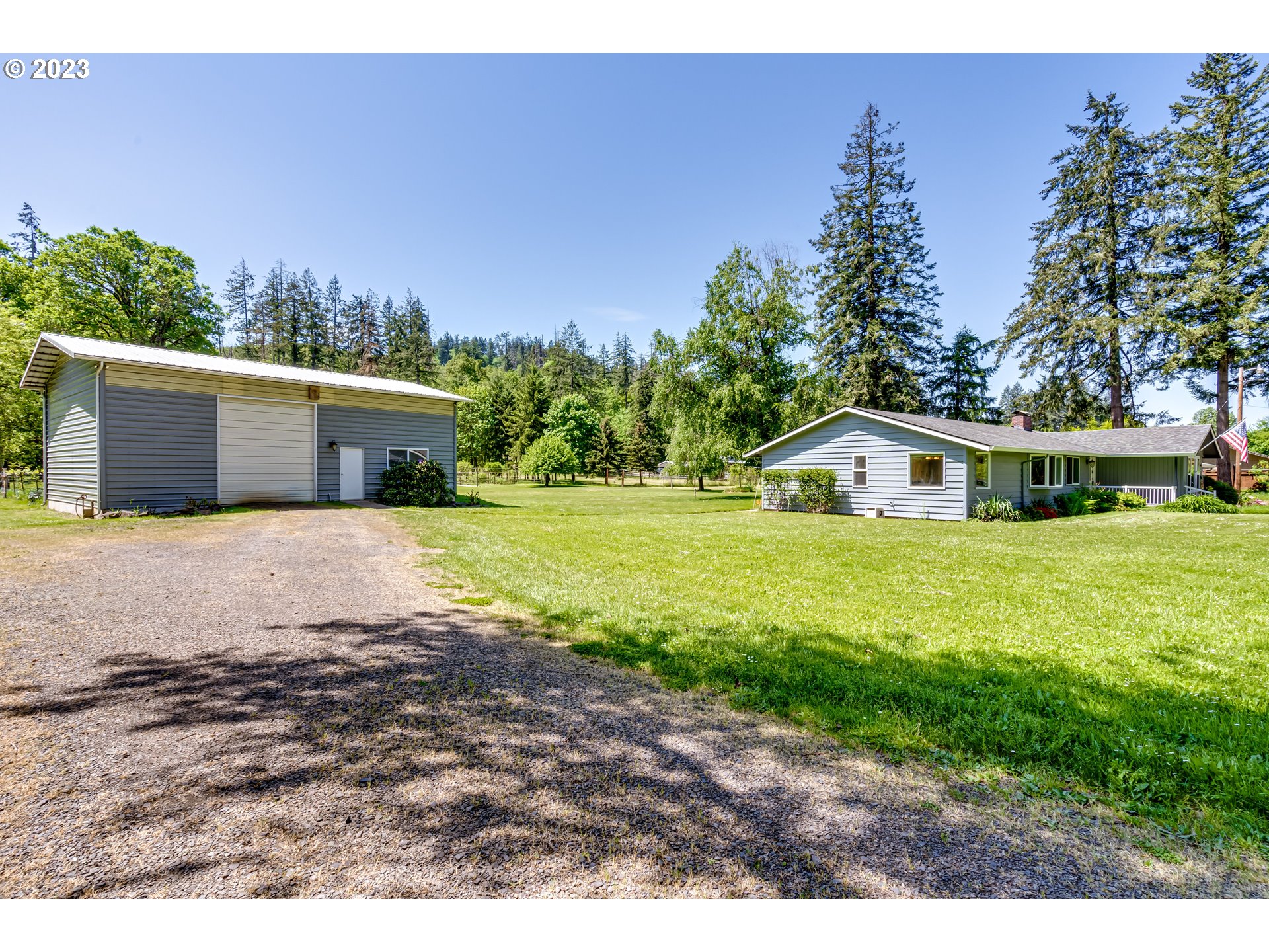 34886 Mathews Road Eugene, OR 97405 - Photo 4 of 48 a white house with a big yard and large trees