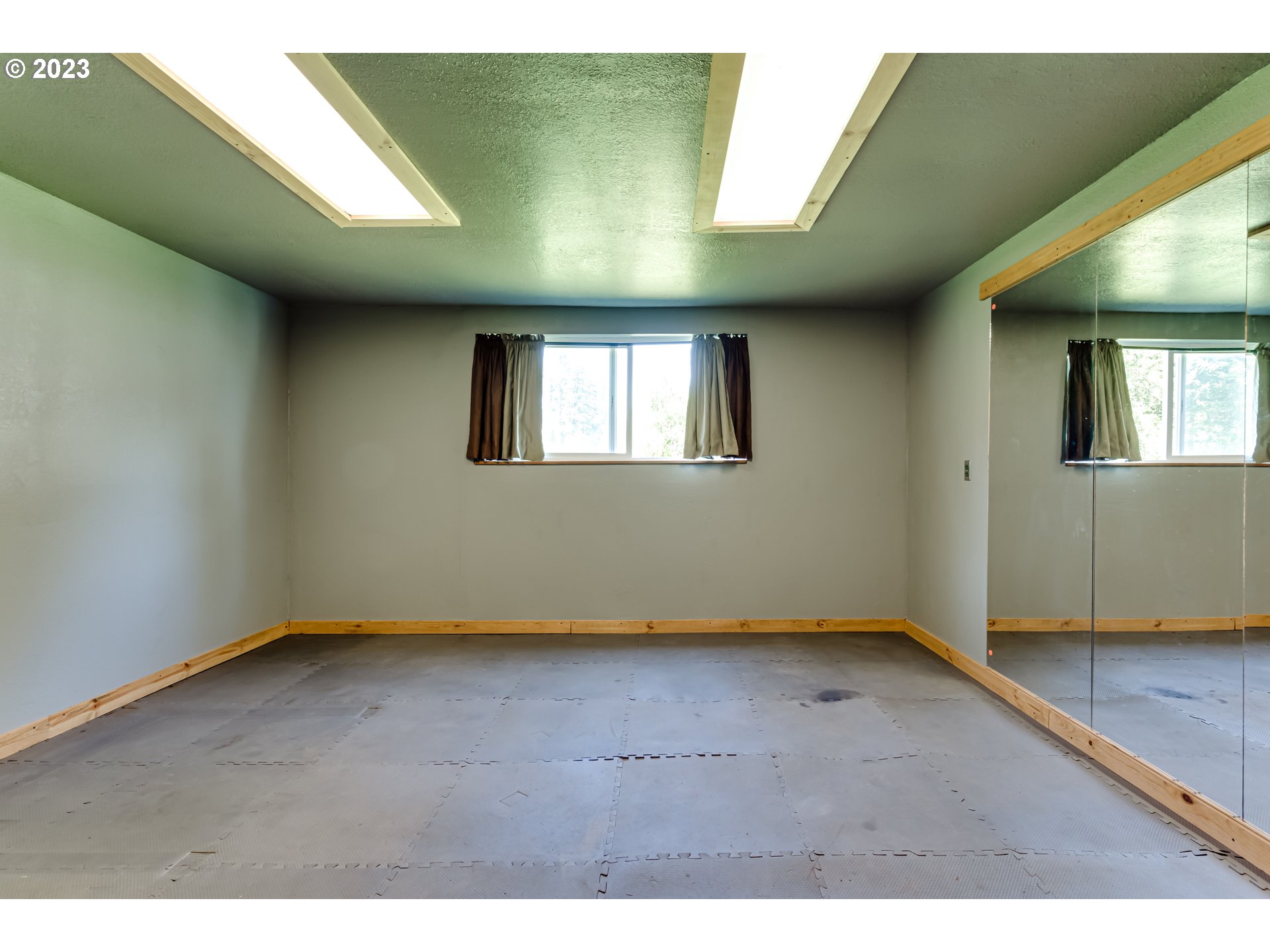 34886 Mathews Road Eugene, OR 97405 - Photo 8 of 48 a view of an empty room with window and wooden floor