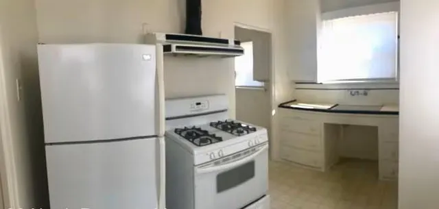 a kitchen with a refrigerator and a stove