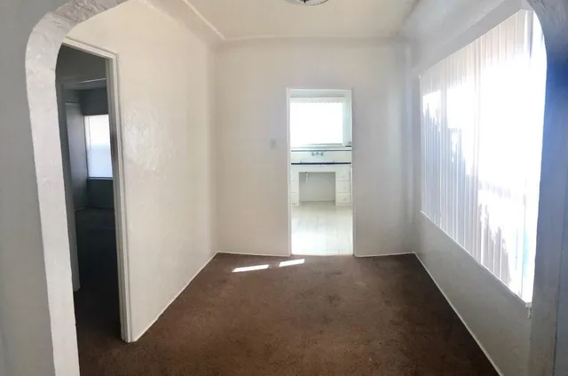a view of an empty room and a window