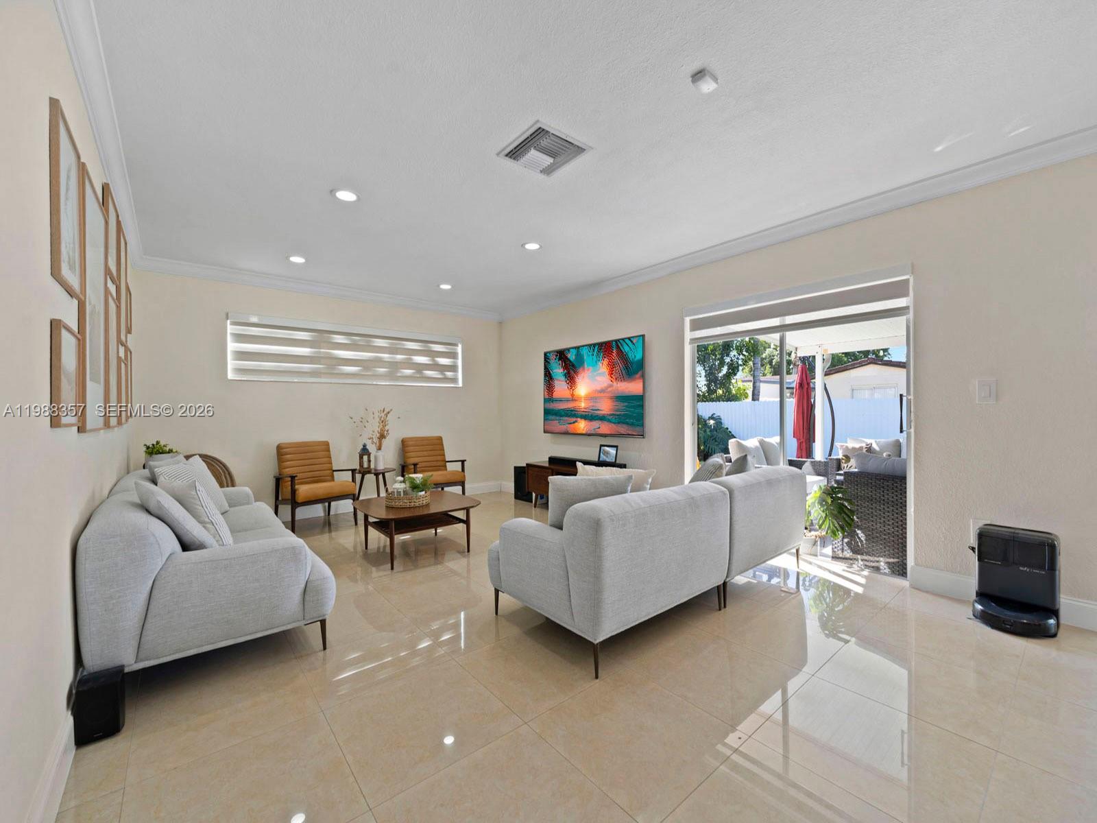 8530 Northwest 179th Street Hialeah, FL 33015 - Photo 11 of 28 a living room with furniture and a flat screen tv