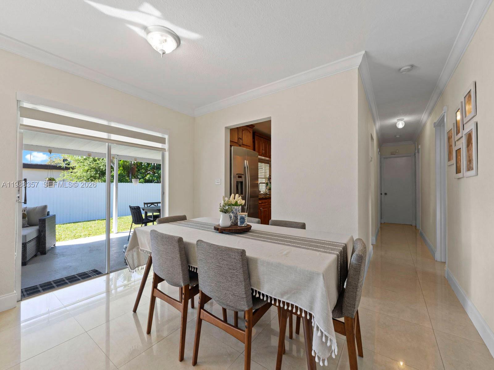 8530 Northwest 179th Street Hialeah, FL 33015 - Photo 15 of 28 a view of a dining room with furniture and window