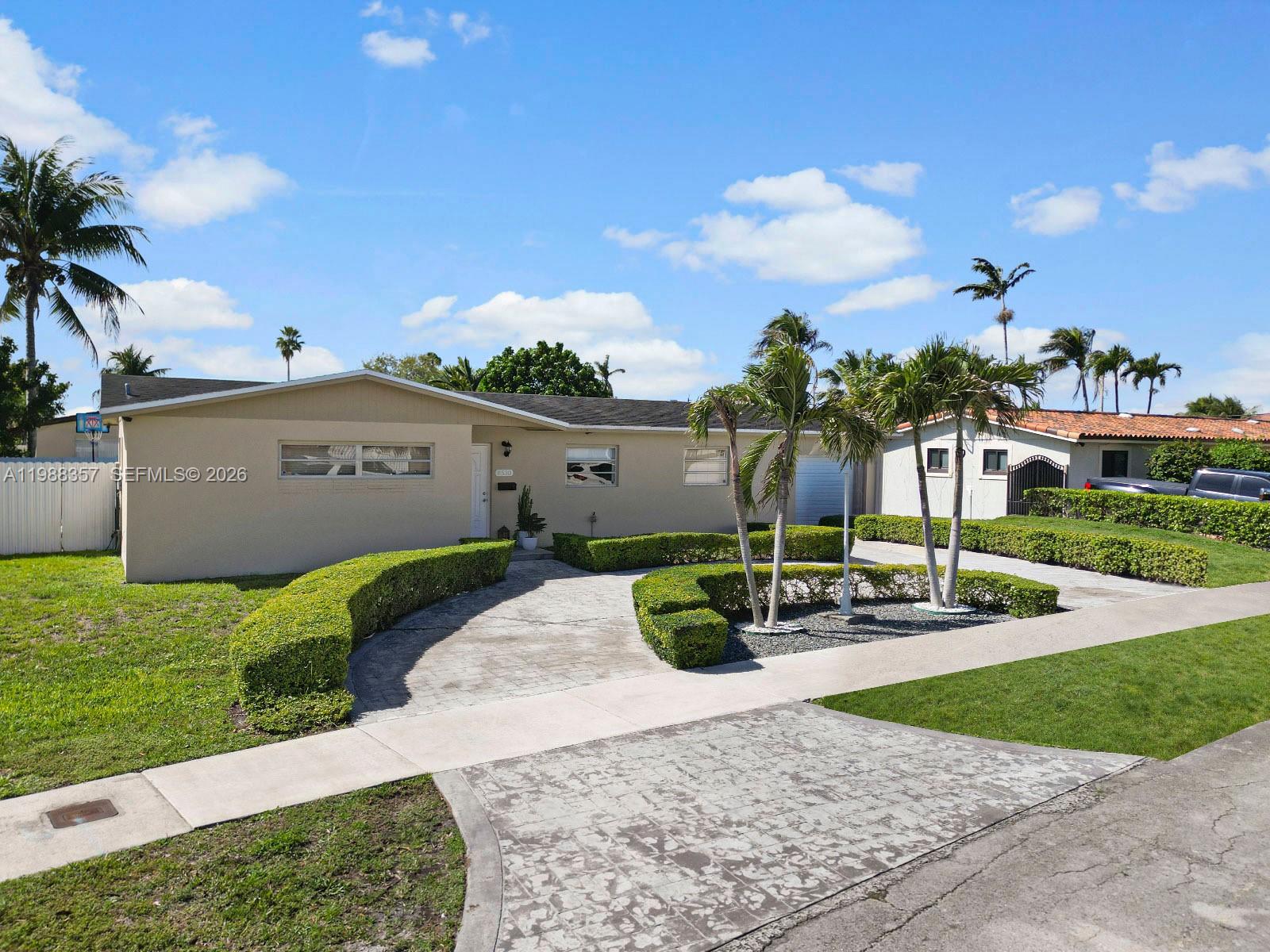 8530 Northwest 179th Street Hialeah, FL 33015 - Photo 2 of 28 a front view of a house with garden and plants