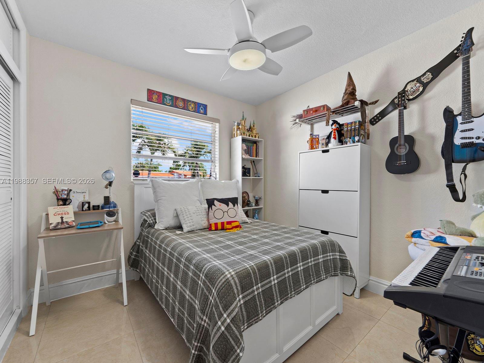 8530 Northwest 179th Street Hialeah, FL 33015 - Photo 21 of 28 a bedroom with a bed and a desk