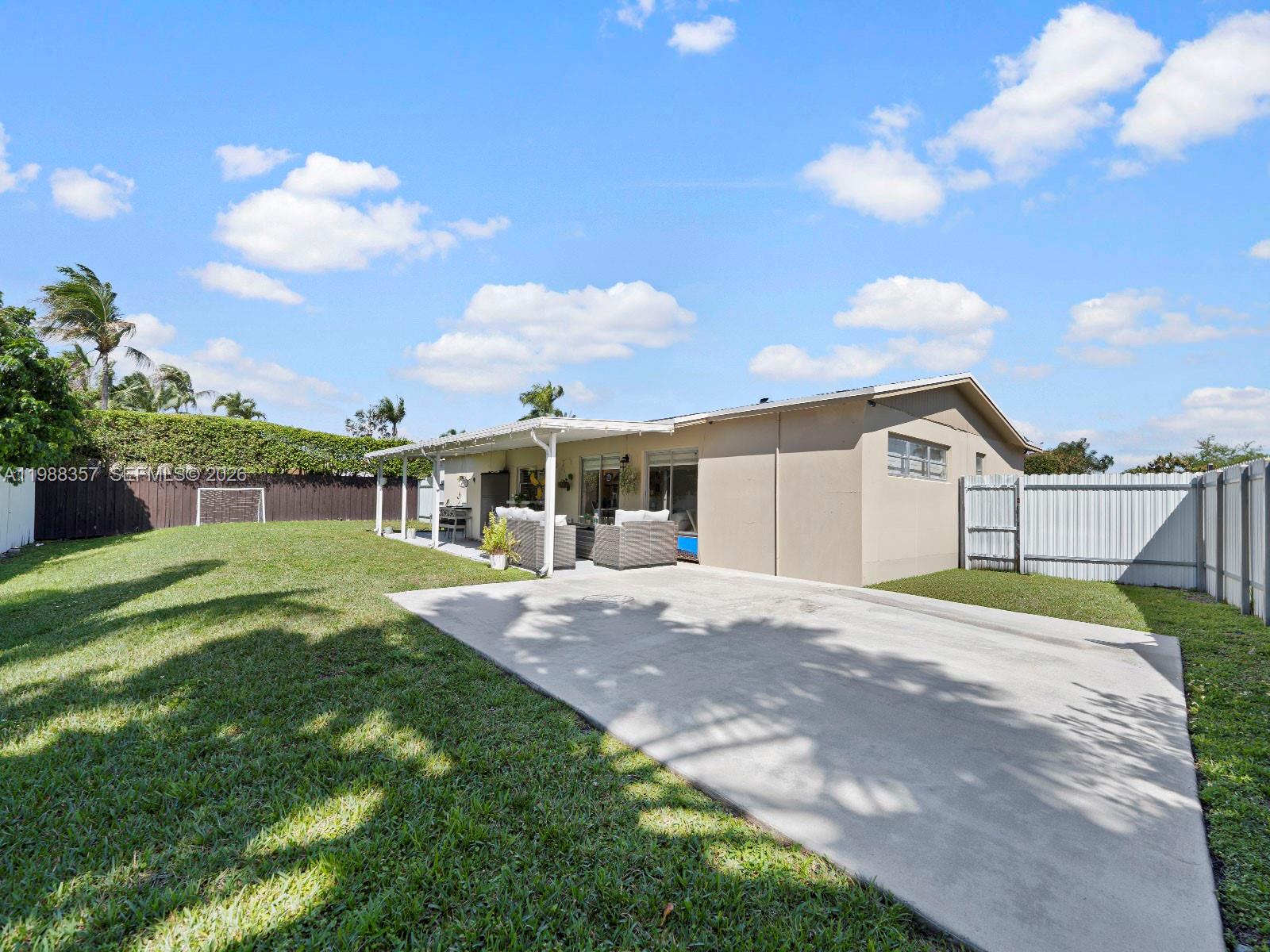 8530 Northwest 179th Street Hialeah, FL 33015 - Photo 27 of 28 a front view of a house with a yard and garage