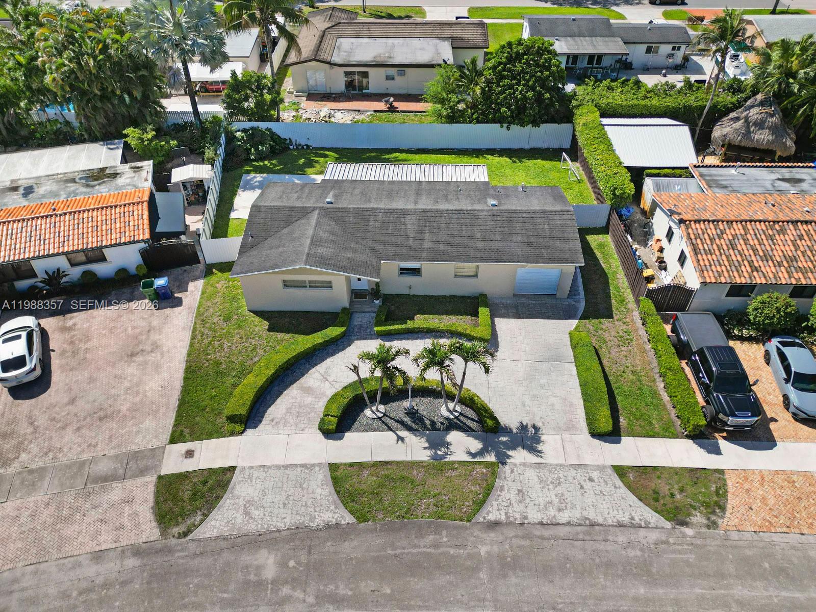 8530 Northwest 179th Street Hialeah, FL 33015 - Photo 4 of 28 an aerial view of a house with garden space and street view