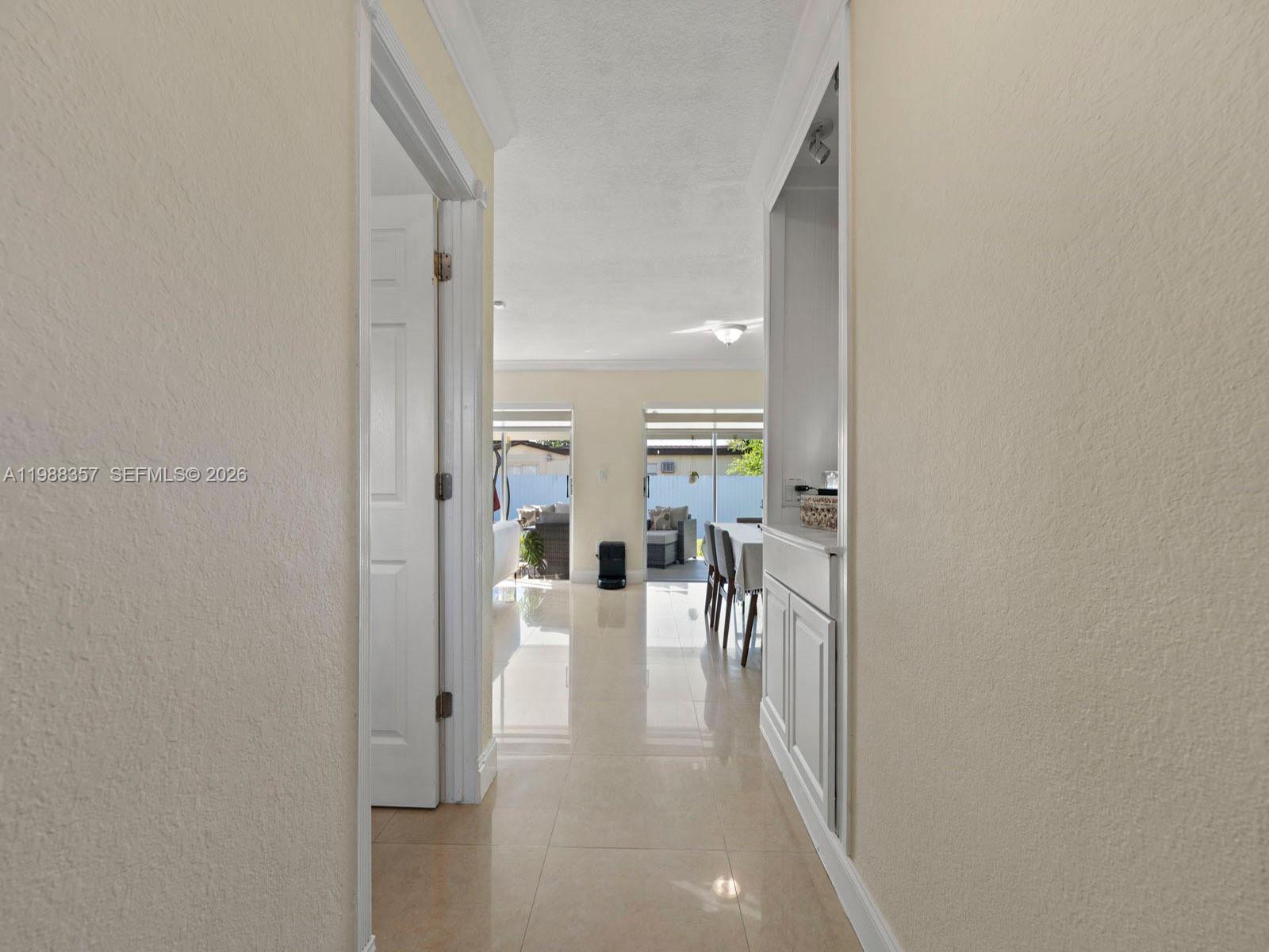 8530 Northwest 179th Street Hialeah, FL 33015 - Photo 10 of 28 a view of a hallway with wooden floor fireplace and living room