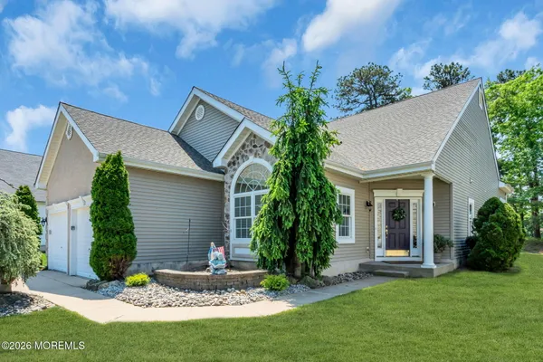 a front view of house with a garden