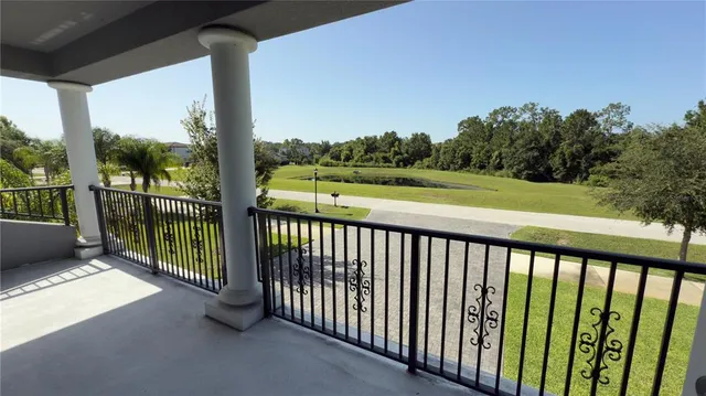 a kitchen with a refrigerator a sink and chairs