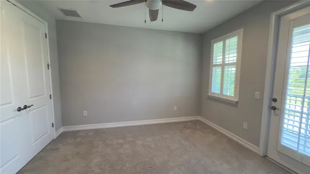 a spacious en suite bathroom with double sink and a mirror