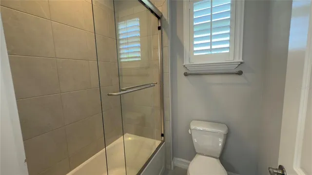 a view of a bathroom from a corridor