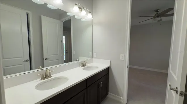 a spacious bathroom with a granite countertop sink and a mirror